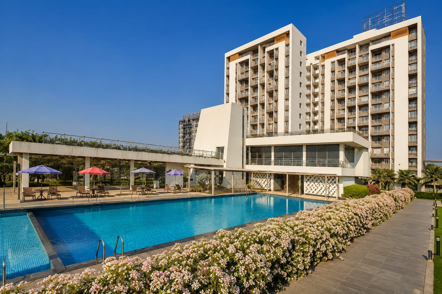 Pool and clubhouse at Little Earth, Pune
